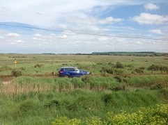 Car on the North Norfolk marsh road
